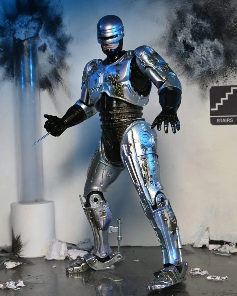 Akcijska figura RoboCop Ultimate Battle Damaged RoboCop s stolom 18 cm fotografija izdelka